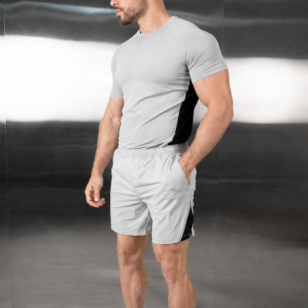 Grey performance tee and training shorts in a gym